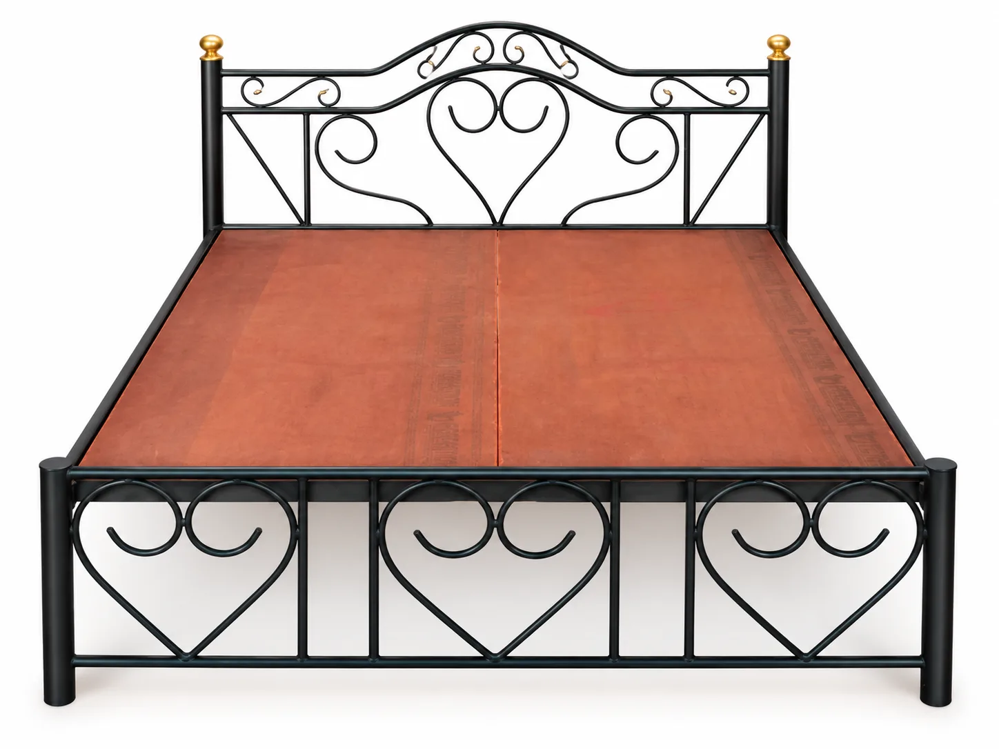 Iron double bed with a heart-pattern footboard.