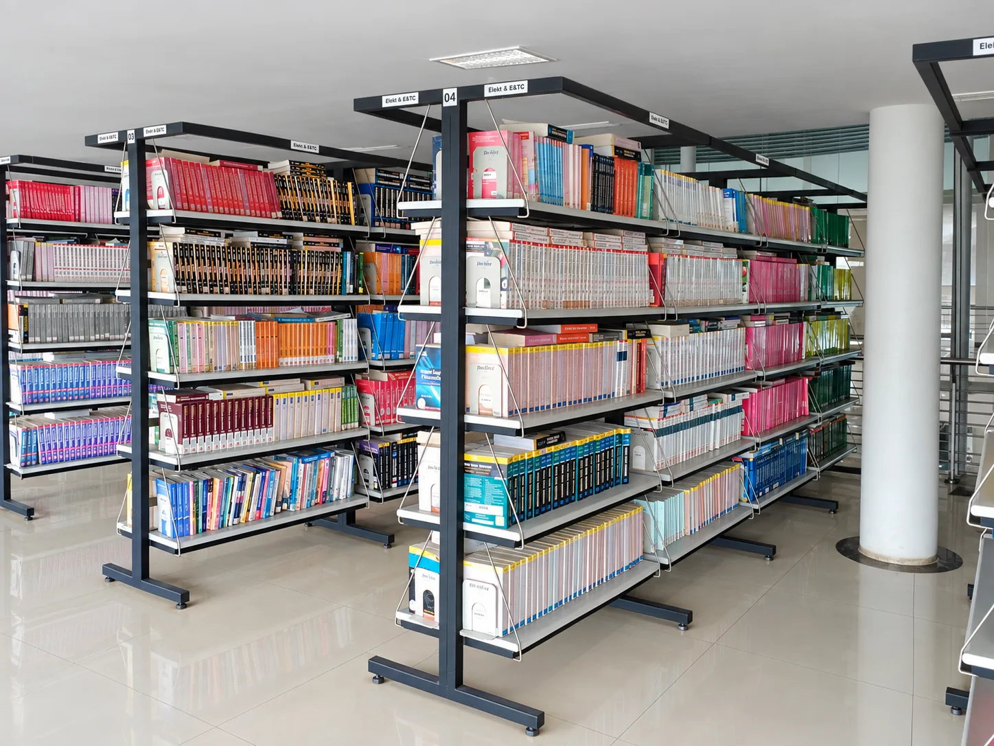 Rows of installed steel library shelves filled with books