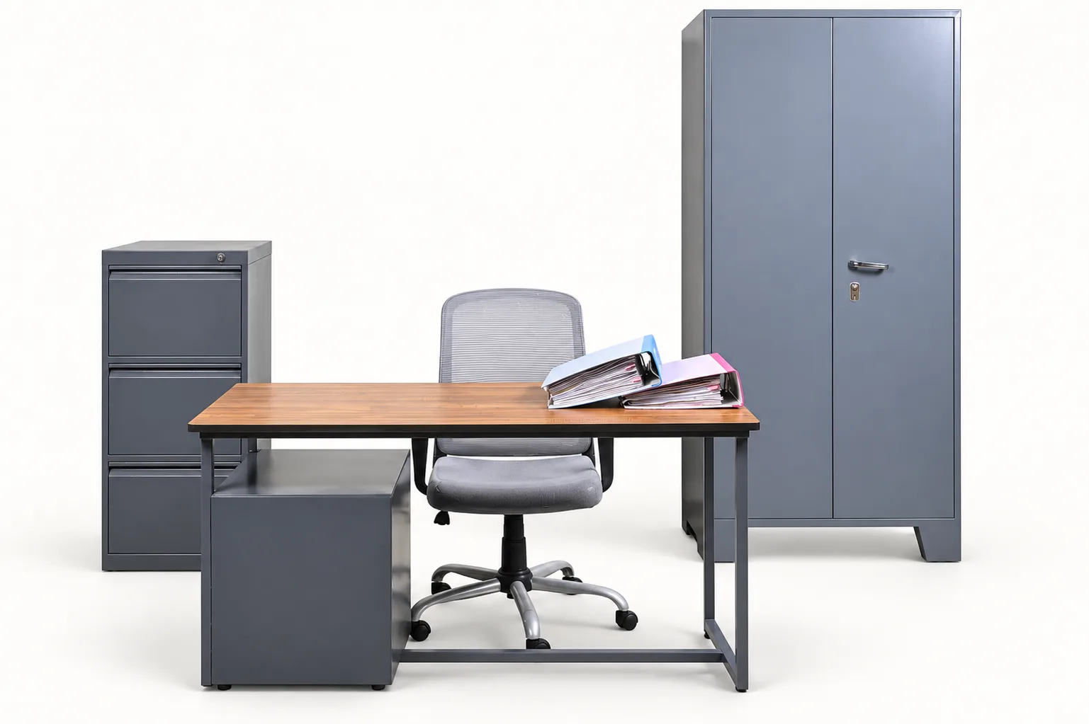 A working office: desk, chair, filing cabinet and a steel almirah.