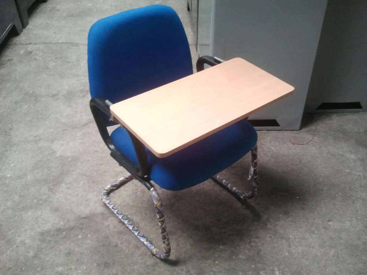Exam chair with a fold away writing pad.