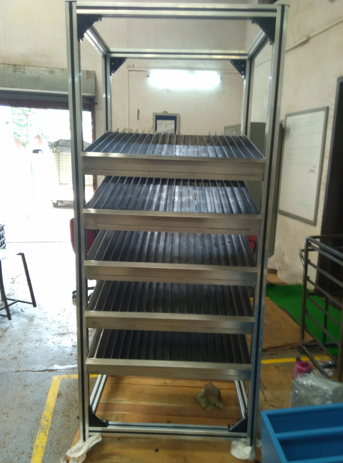 Stainless steel trolley rack on castors.