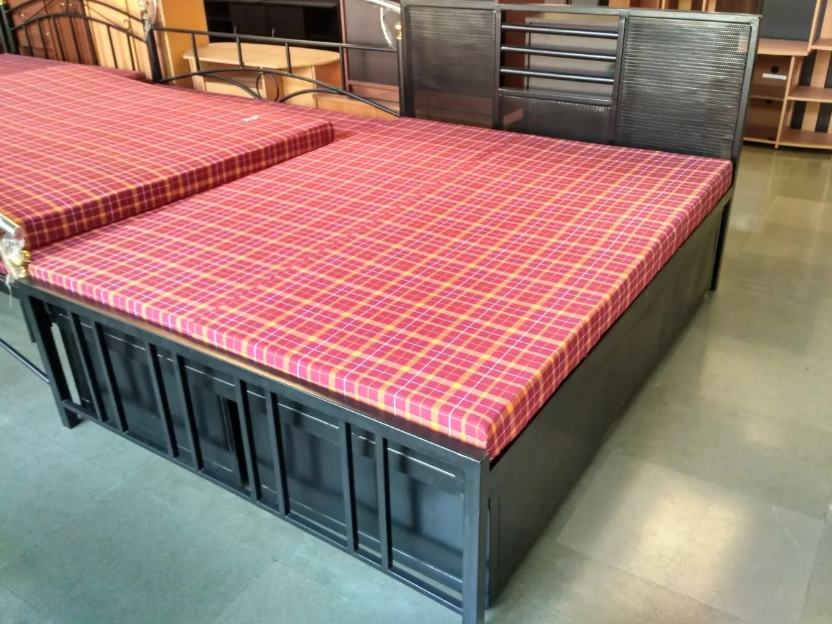 Steel double bed with drawers built into the base.