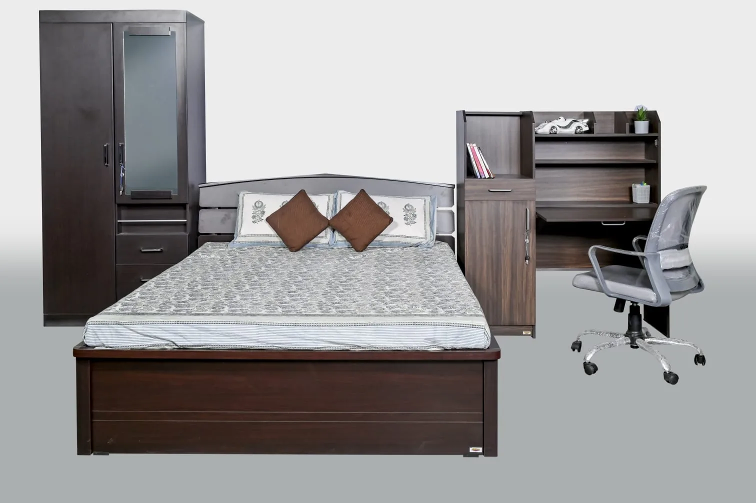 A full bedroom: bed, wardrobe, dressing table and chair.