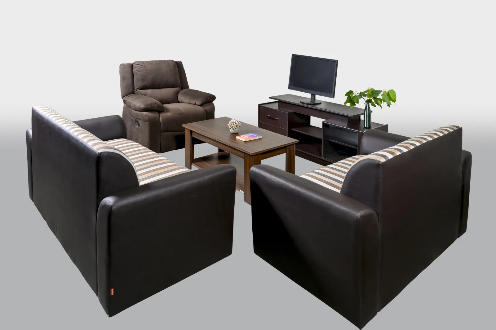 A living room with a recliner, sofas, television unit and centre table.