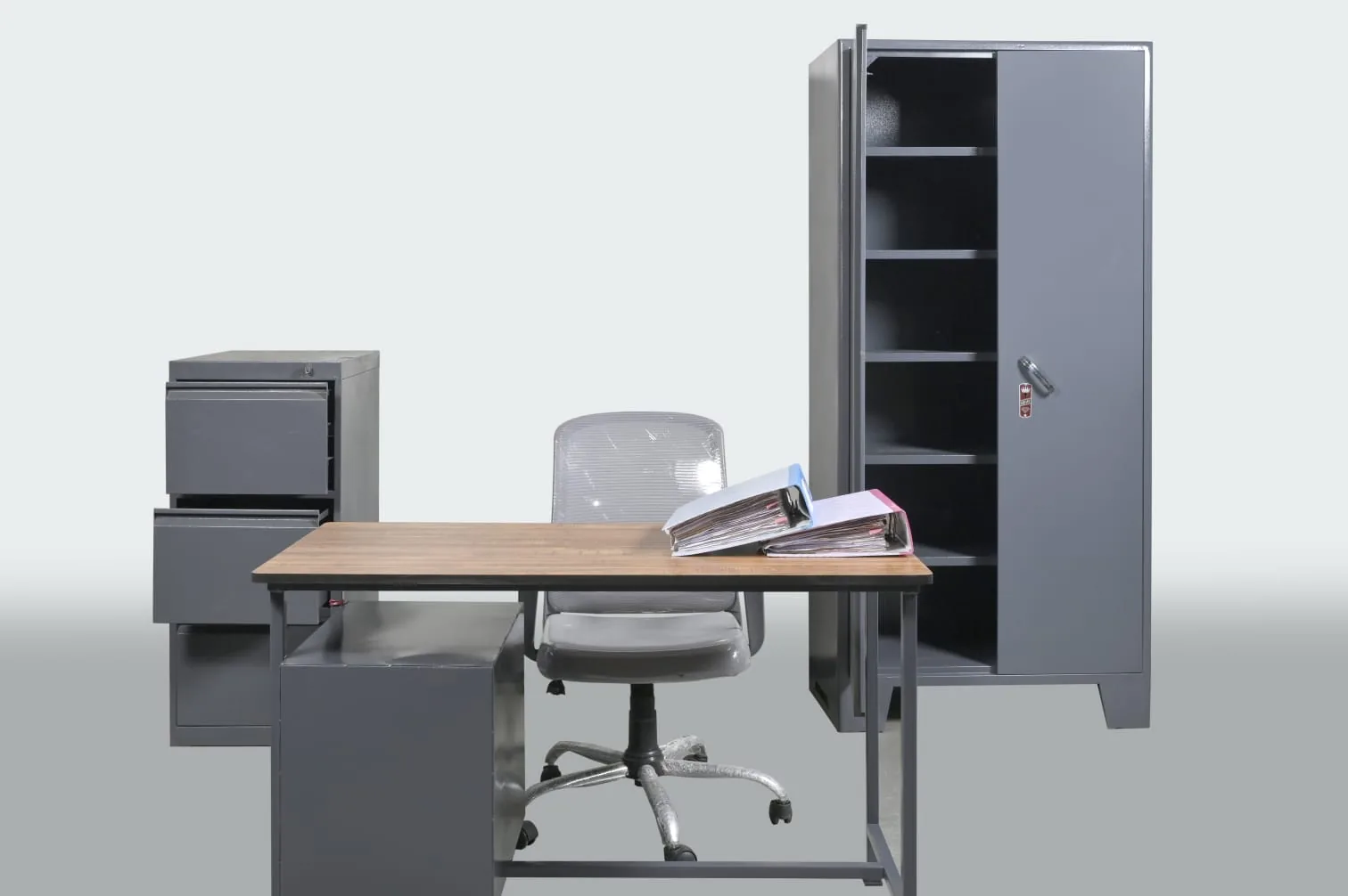 An office fitted end to end: desk, chair, filing cabinet, almirah.